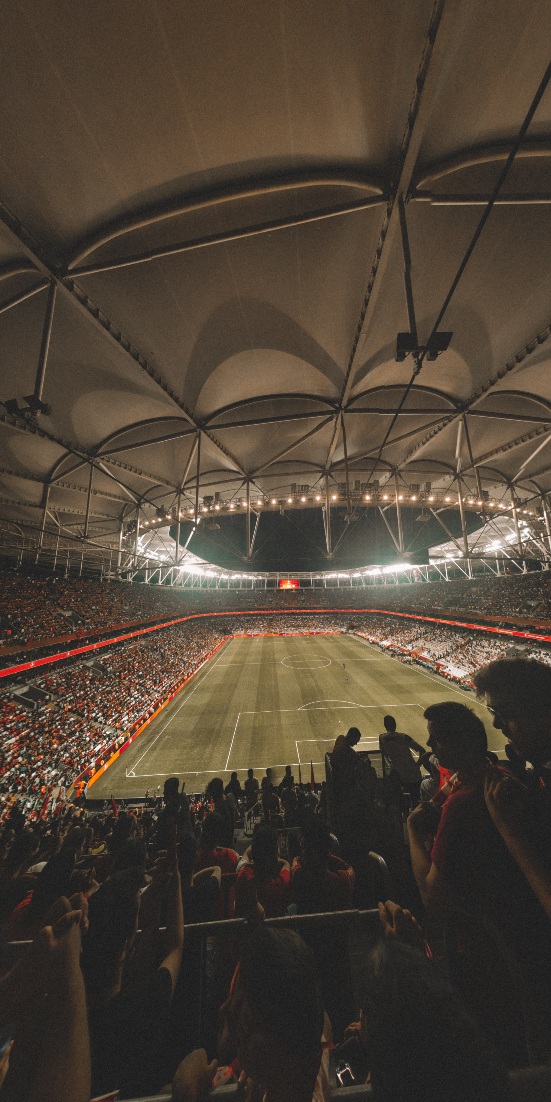 Fans sitting on tribunes in football stadium